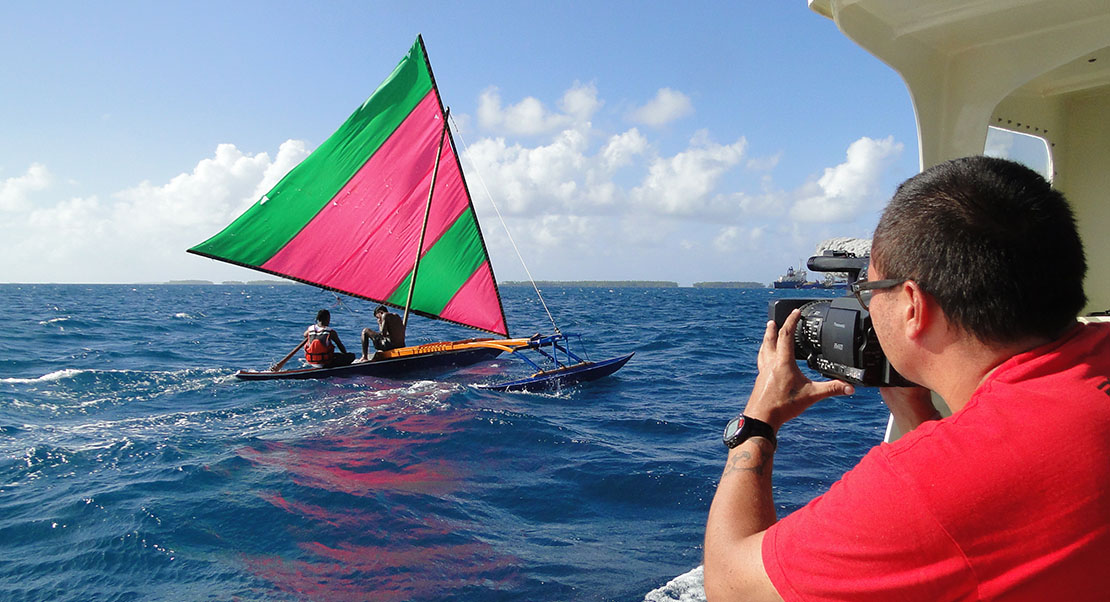 Fiji photographer from the South Pacific Forum shoots a canoe underway.